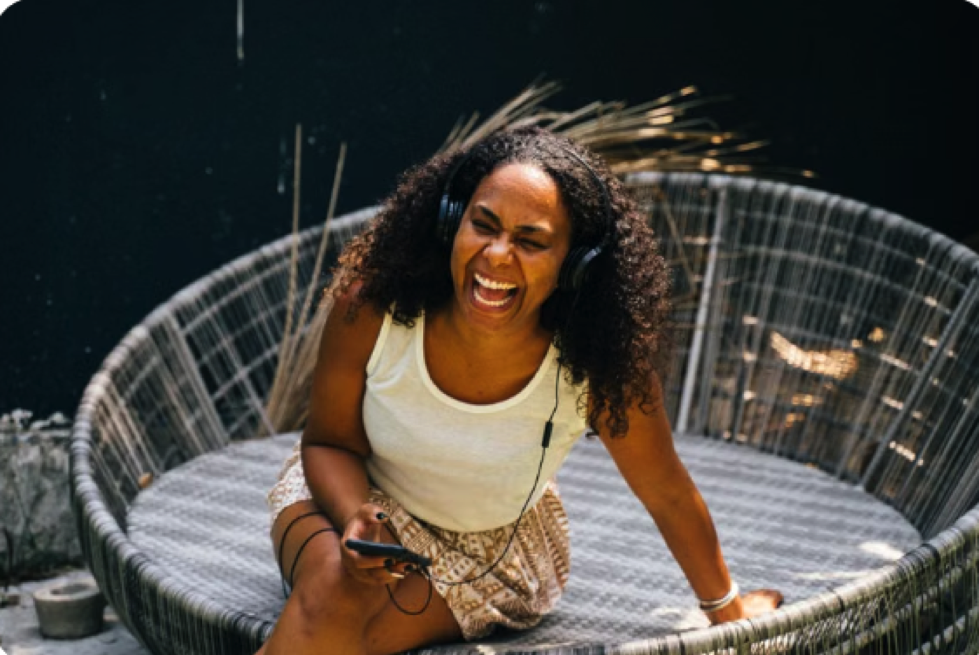 A woman laughing while she listens to a story